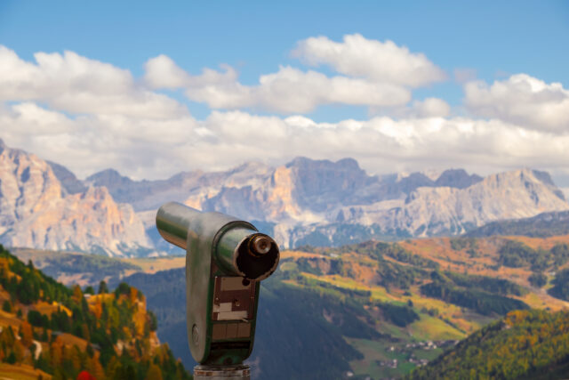 Typical hilly mountain landscape in the Dolomites with beautiful autumn colors on a foggy morning near the town of Cortina d’Ampezzo in northern Italy.